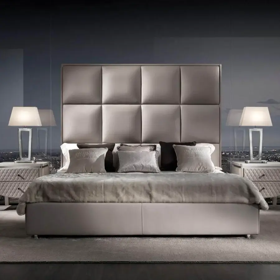 Elegant DV Home Collection Duke bed with multilayer structure covered in light grey fabric and quilted headboard