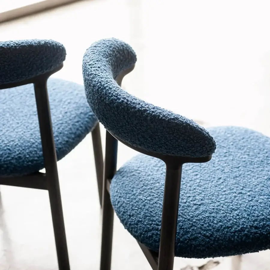 Elegant Bross Lindy chair with muted blue nubby textile upholstery and sleek dark-toned wood frame crafted in Italy