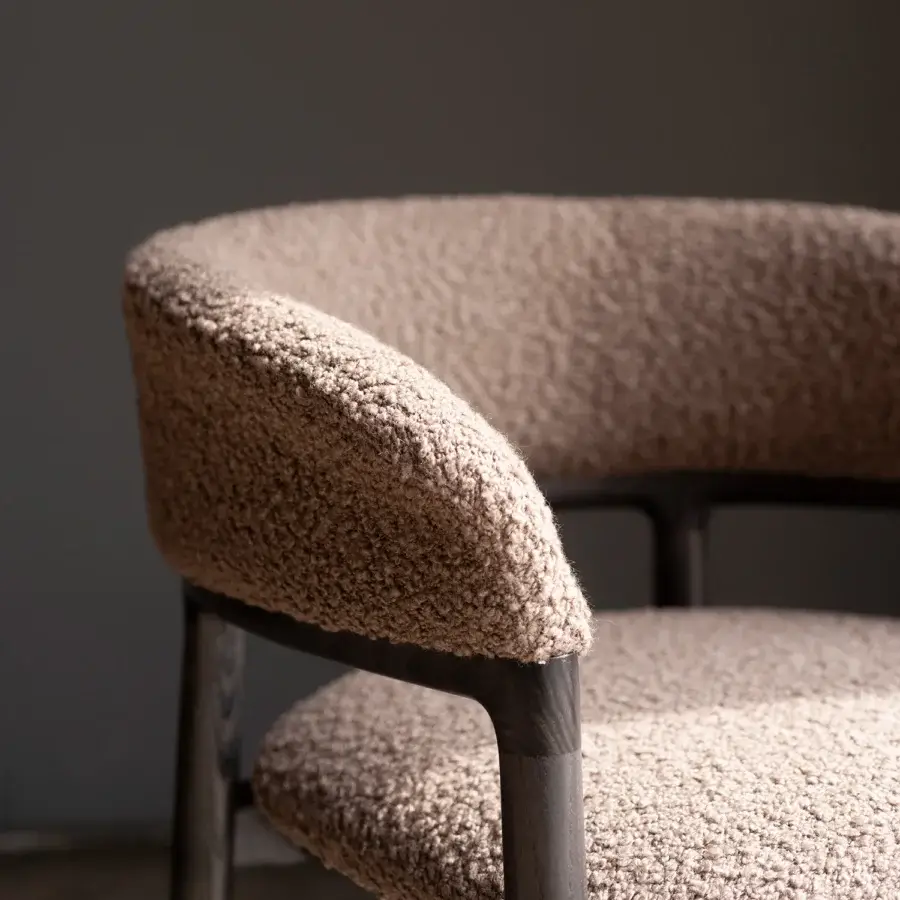 Lavish Bross Lindy armchair with curved silhouette and neutral textured premium fabric upholstery in a dark stained wooden frame