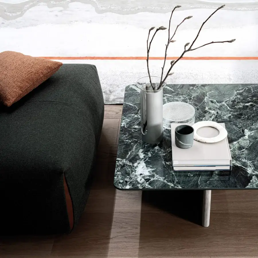 Elegant Cierre1972 Wings coffee table with aerodynamic leather legs and glossy dark green ceramic top
