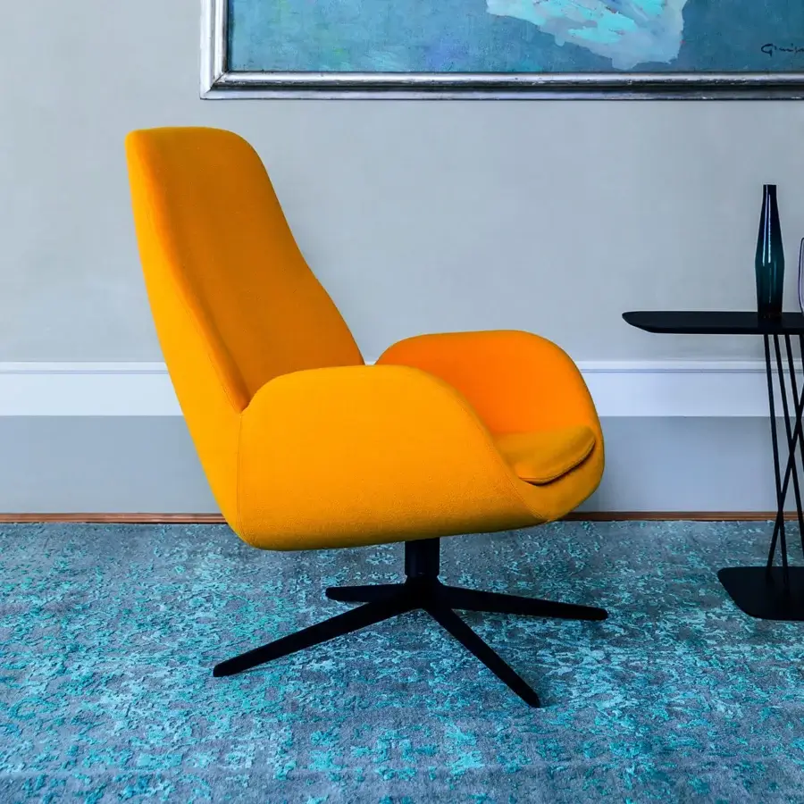 Captivating Bross Mysa lounge chair with vibrant yellow-orange fabric upholstery and lacquered metal base