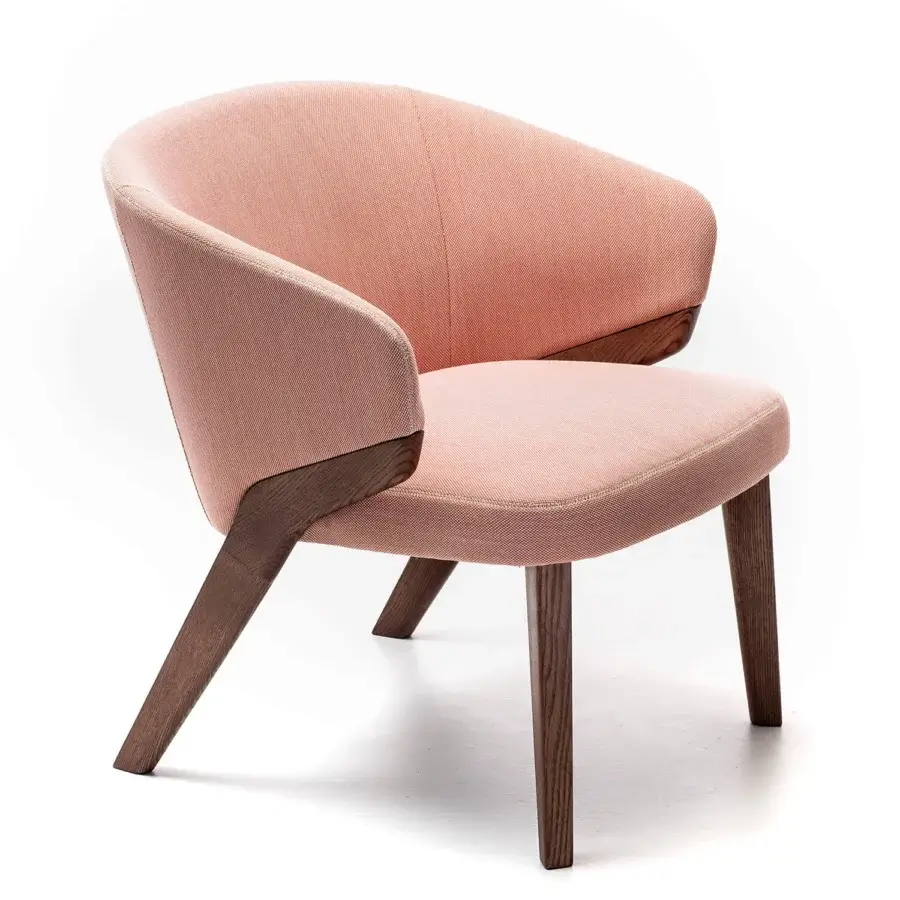 Exceptional Bross Nora lounge chair with light reddish-pink fabric upholstery and angled wooden legs exhibiting a subtle matte finish