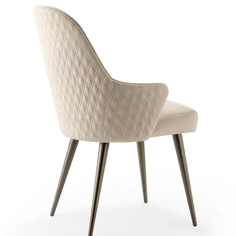 Superior Reflex Ludwig chair upholstered in light beige textile with diamond quilting and dark metal legs