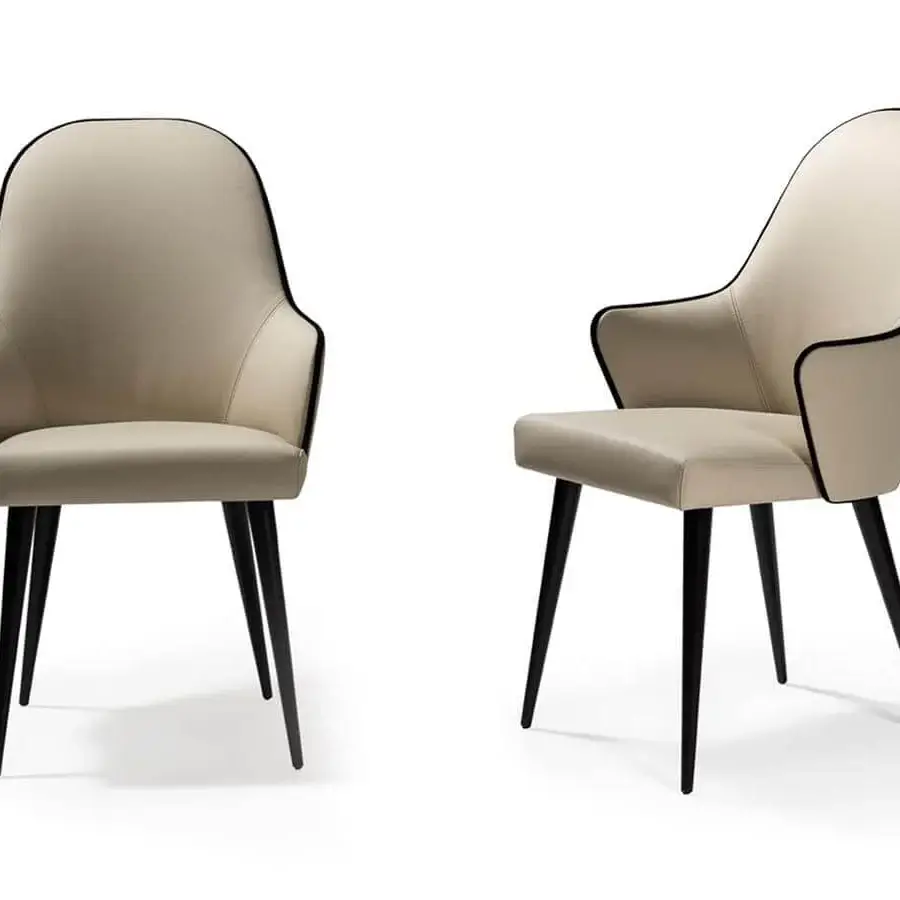 Superior Reflex Ludwig chair upholstered in light cream fabric with sleek tapered matte metal legs and subtle black piping