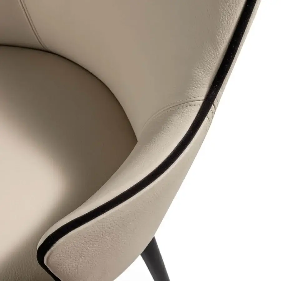Exceptional Reflex Ludwig chair upholstered in light beige material with contrasting black piping