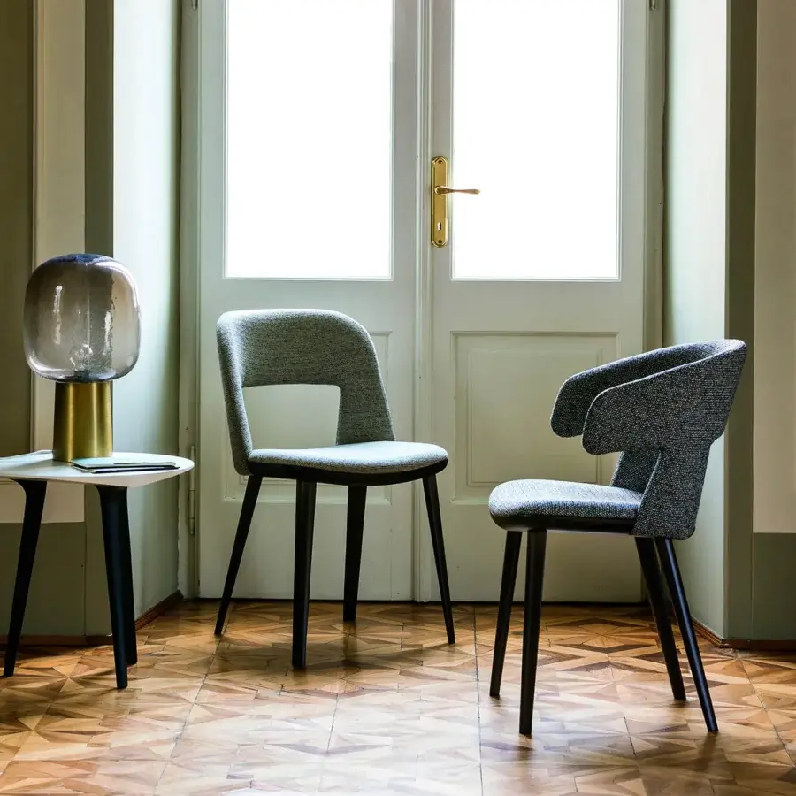 Distinguished Bross Path armchair with fully upholstered heathered medium gray fabric and sleek tapered black wooden legs