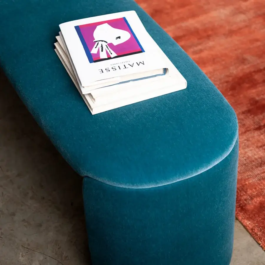 Elegant Bross Petal bench crafted in Italy with plush teal fabric and seamless curved lines