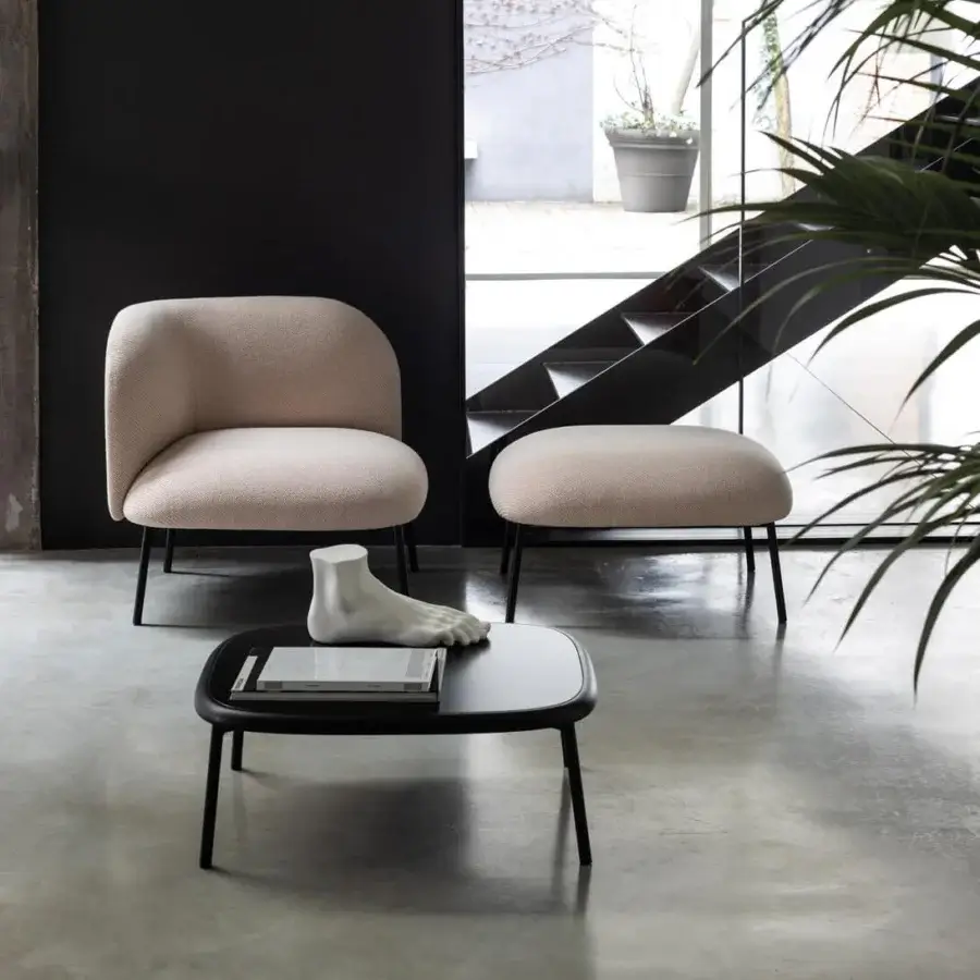 Distinguished Bross Sit ottoman with plush light beige textured fabric and slender black metal legs