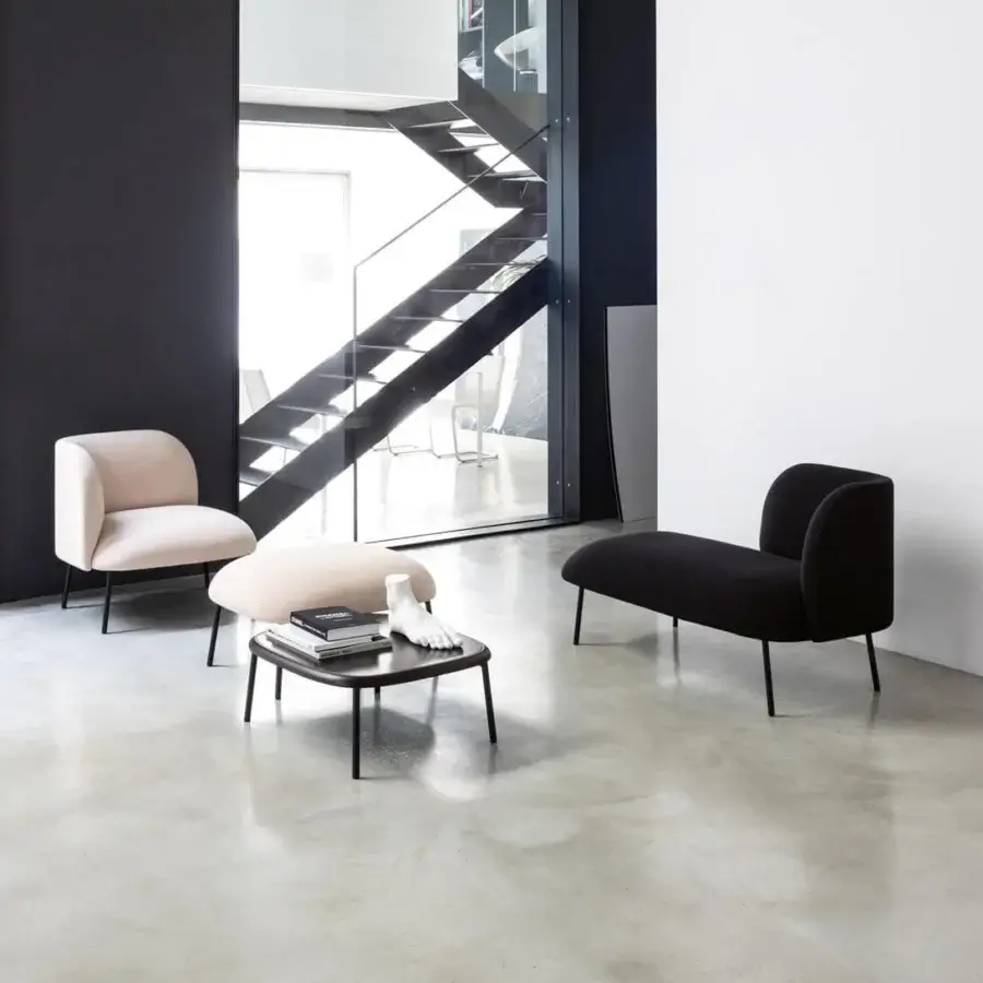 Distinguished Bross Sit chaise lounge crafted with black textile upholstery and a sleek metal frame in Italy
