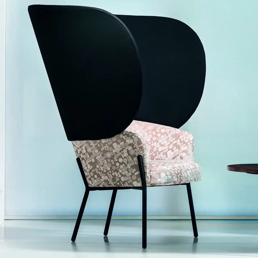 Distinguished Bross Wam lounge chair crafted in patterned textile with light pink, beige, and white shapes with matte black metal legs