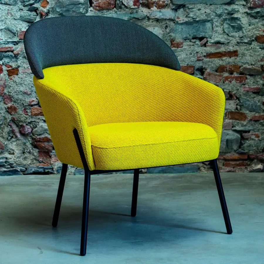 Superior Bross Wam lounge chair upholstered in textured yellow fabric with dark gray textile and matte black metal frame