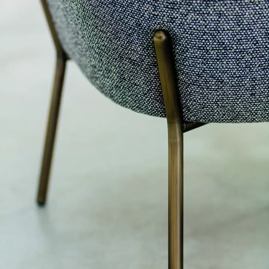 Superior Bross Wam lounge chair with speckled gray-blue woven fabric and bronze-finished metal legs