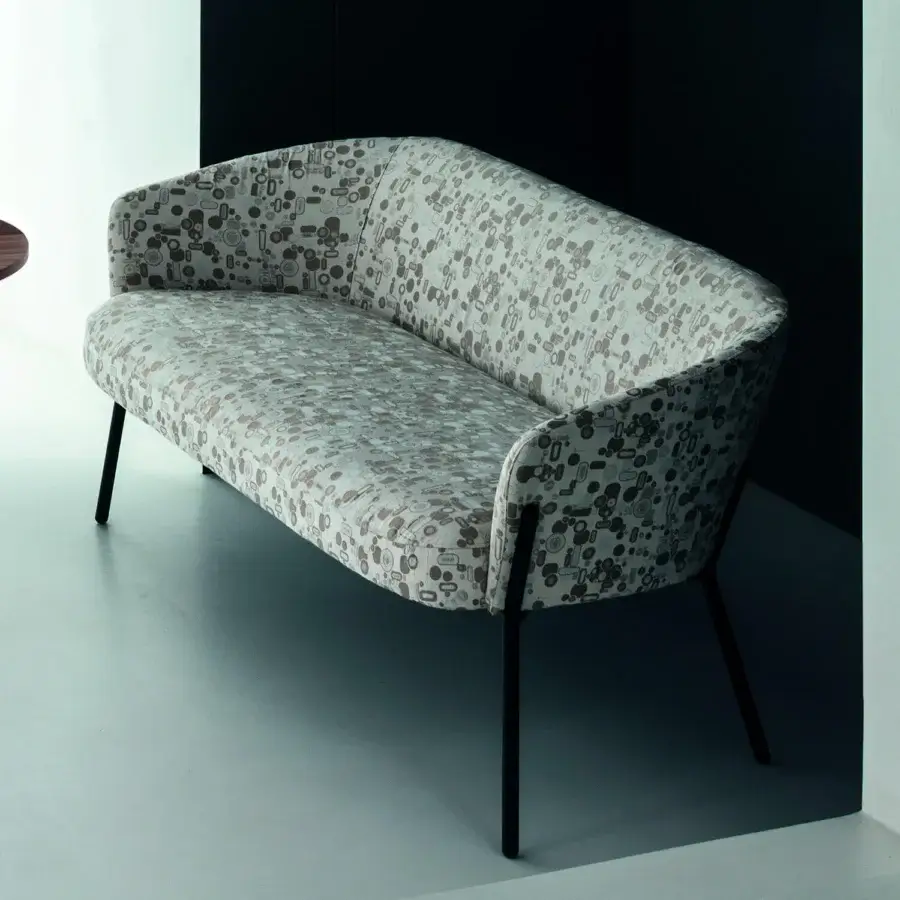 Exceptional Bross Wam sofa with curved silhouette and light patterned fabric upholstery built with dark metal legs