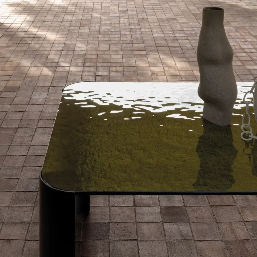 Distinguished Cierre1972 Riviera coffee table with rectangular olive-green glass tabletop and sleek matte black cylindrical legs