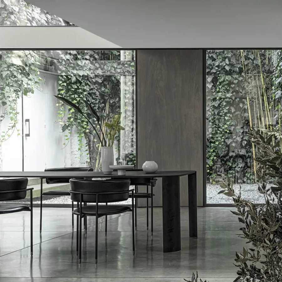 Distinguished Cierre1972 Riviera table with graceful legs and dark-toned material built with a matte finish