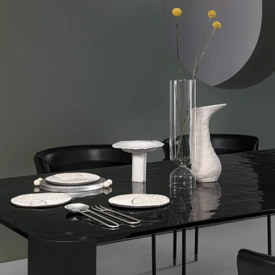 Superior Cierre1972 Riviera table with dark glass top exhibiting lighter patterns and minimalist metal frame