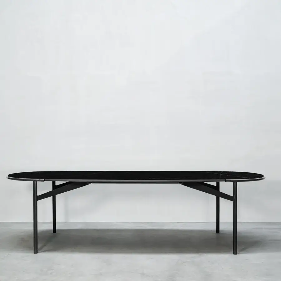 Elegant Cierre1972 Mac table crafted in Italy with oval matte stone-like tabletop and sleek dark metal frame