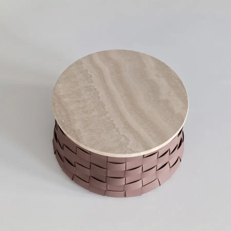 Distinguished Cierre1972 Dama coffee table with woven mauve leather base and light stone top displaying natural beige swirls