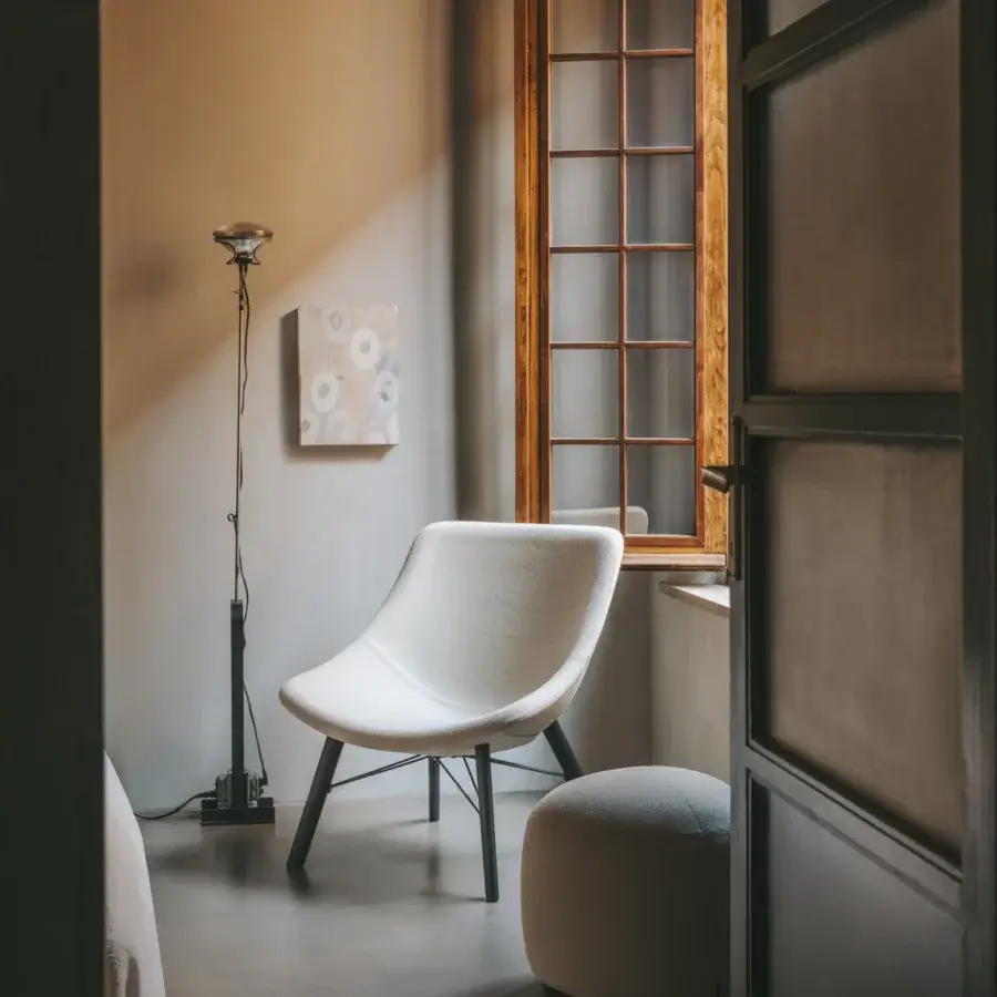 Distinguished Lapalma Auki lounge chair with curved form upholstered in light textile and natural solid ash wood base