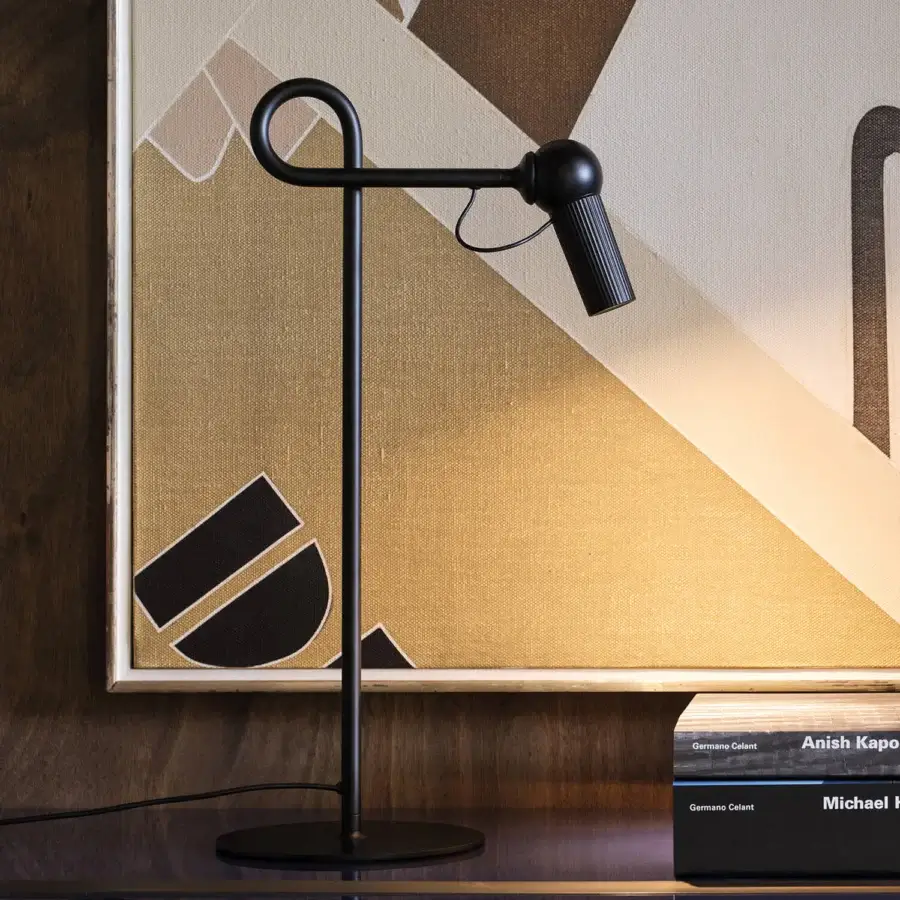 Superior Kundalini Bird table lamp with sleek geometric form in matte black coated metal and varnished aluminum head