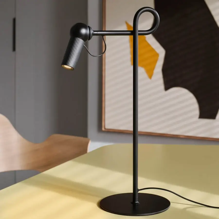 Distinguished Kundalini Bird table lamp with slender matte black silhouette crafted in varnished aluminum and coated metal