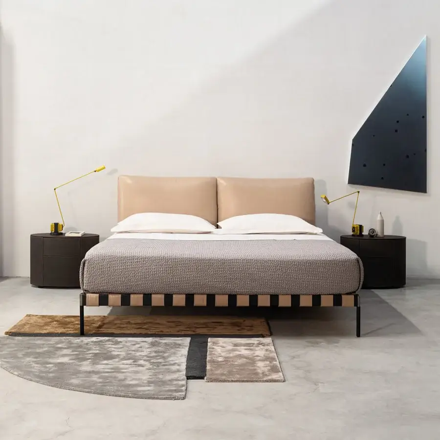 Elegant Cierre1972 Oscar bed with light tan upholstery and a vertically striped dark brown frame built with thin legs