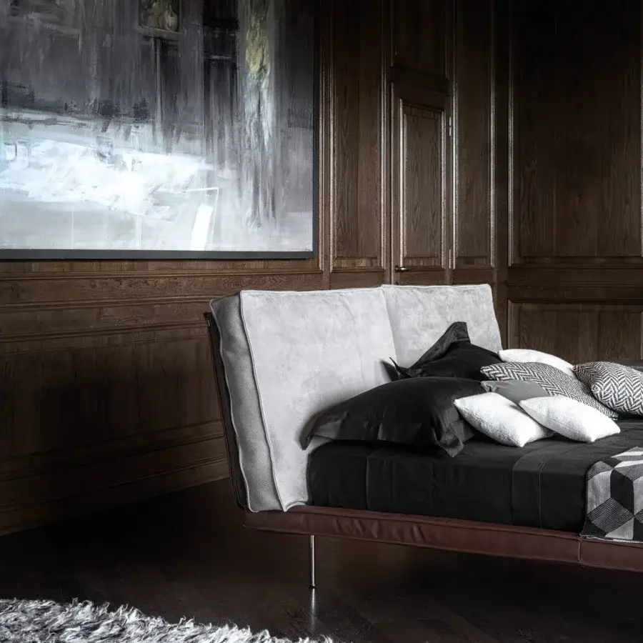 Elegant Cierre1972 Divine bed with light gray textile upholstery and rich brown leather-like frame built on thin metal legs