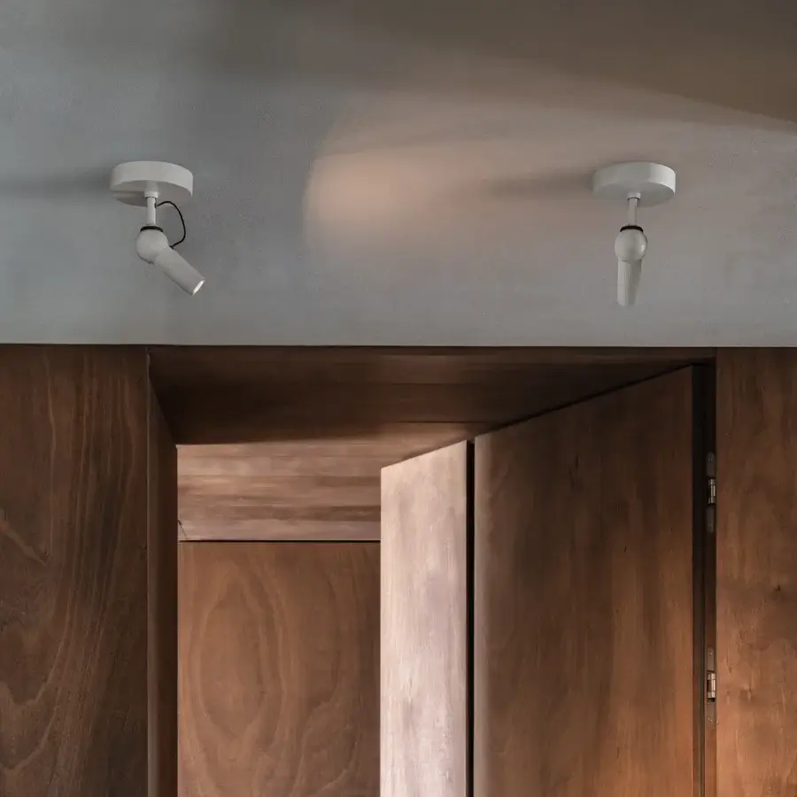 Exceptional Kundalini Bird ceiling lamp with die-cast varnished aluminum head and coated metal in a crisp white finish