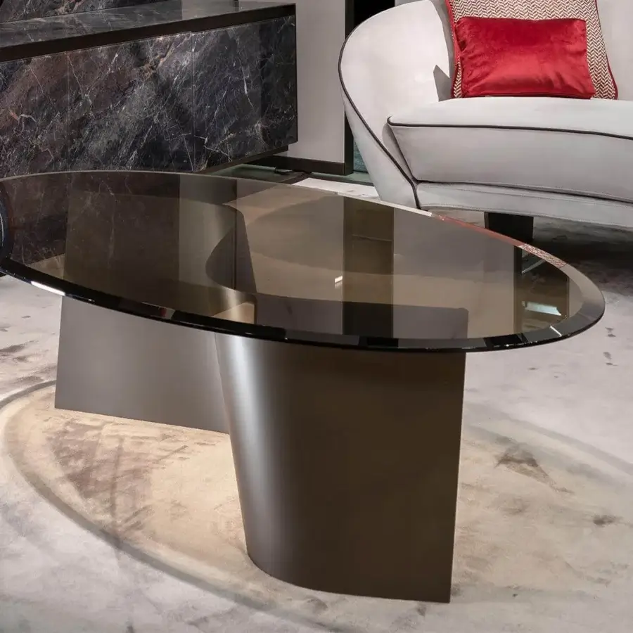 Distinguished Reflex Esse table with curved dark brass base and sleek bronze glass tabletop with beveled edges