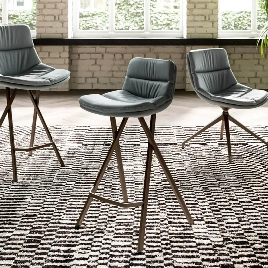 Superior Ozzio Italia Milo stool with padded seat upholstered in muted gray-blue material and dark metal legs