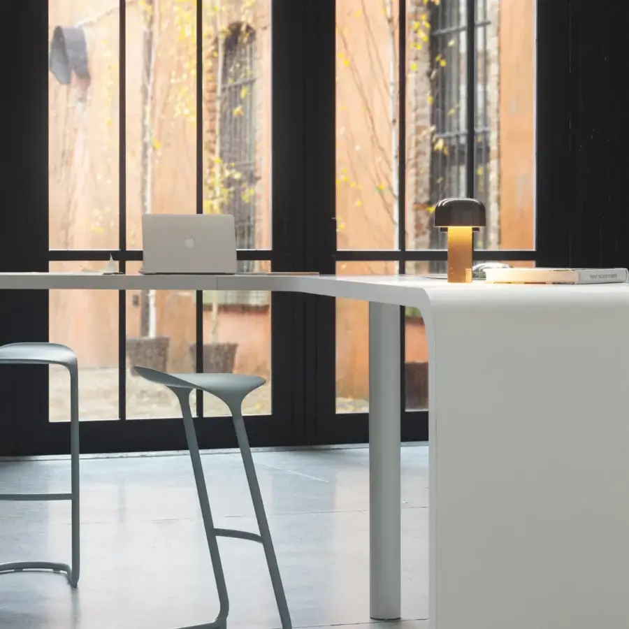 Distinguished Lapalma Brunch workstation with a curved white laminate top and sleek white powder-coated metal base for cable management