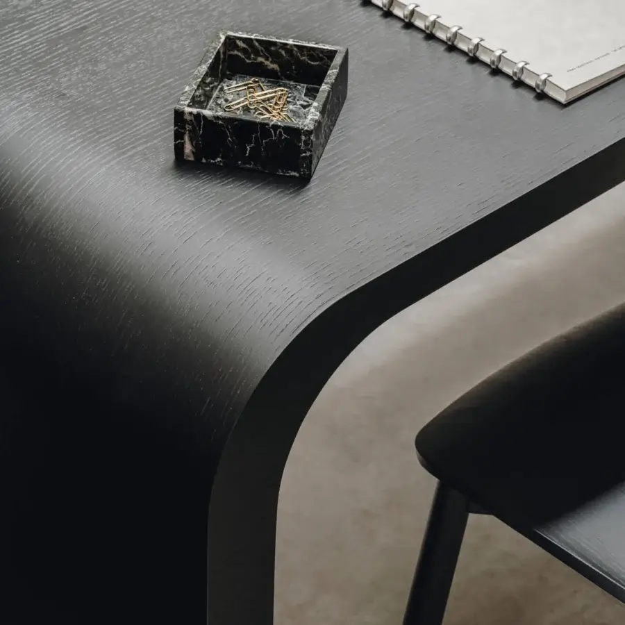 Superior Lapalma Brunch workstation with a curved honeycomb board top in a black veneer and black powder-coated metal base