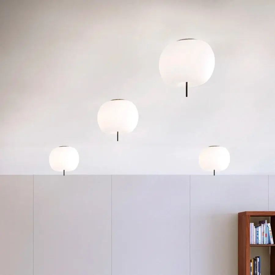 Superior Kundalini Kushi ceiling lamp with an opal diffuser and black metallic body exhibiting natural curves