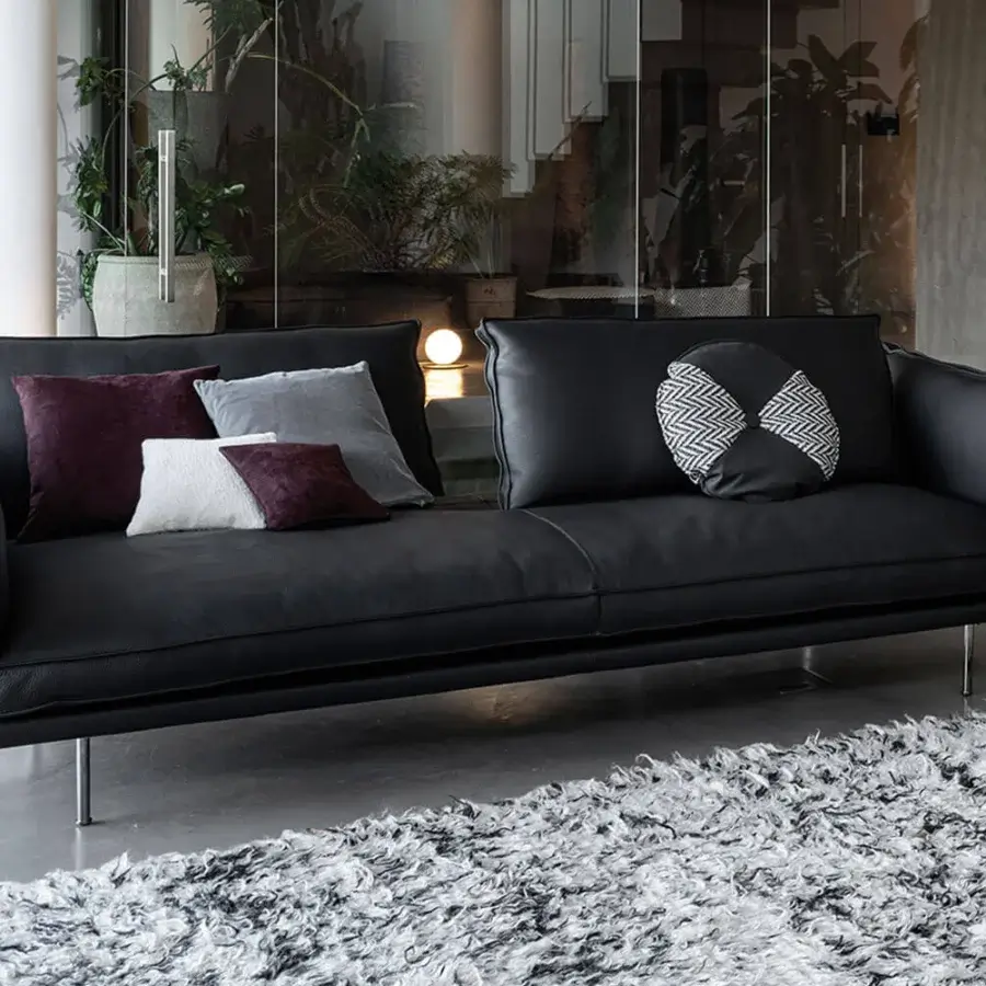 Distinguished Cierre1972 Divine sofa with a low profile and matte black textile upholstery, complemented by satin finish metal legs