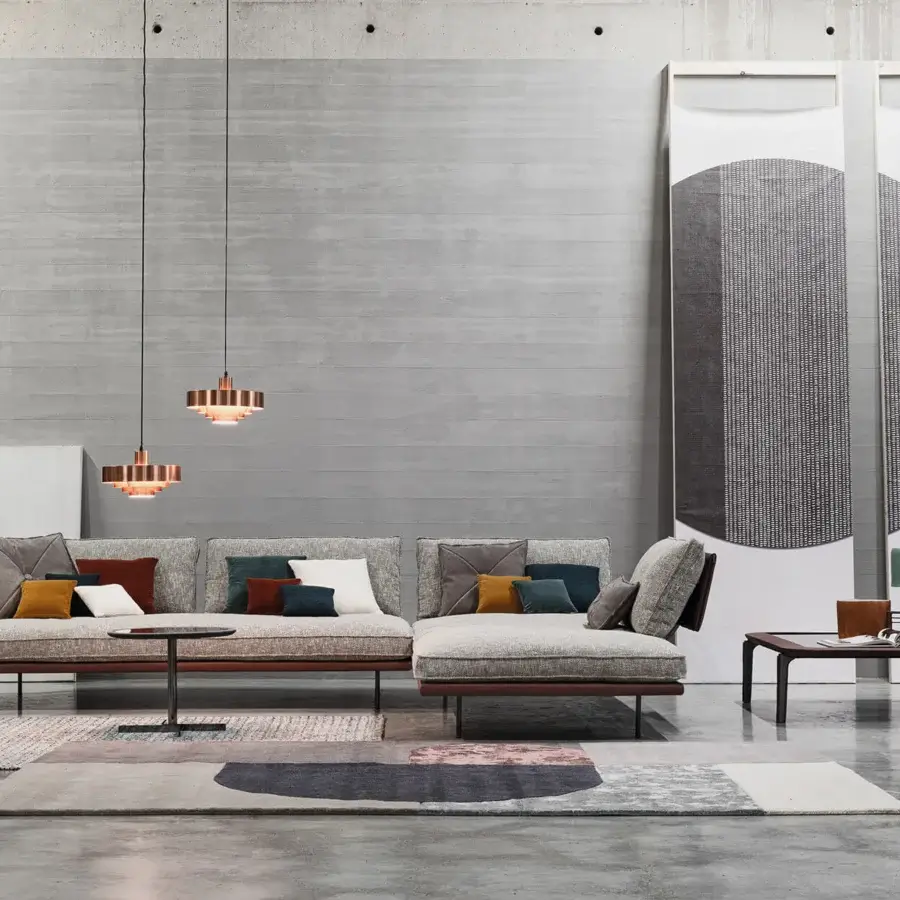 Elegant Cierre1972 Divine sectional with light gray textile upholstery, textured finish and sleek metal accents