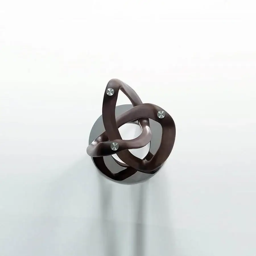 Distinctive Porada Infinity table with a triquetra base crafted in Canaletto walnut and sleek glass top secured with a grey pewter metal ring