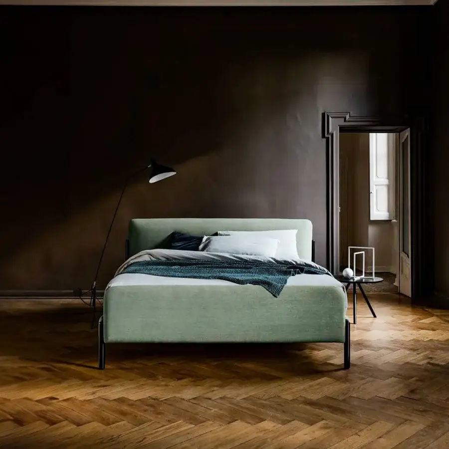Exceptional Bolzan Letti Flag bed with muted green textile upholstery and dark metal legs built with elegant brass accents