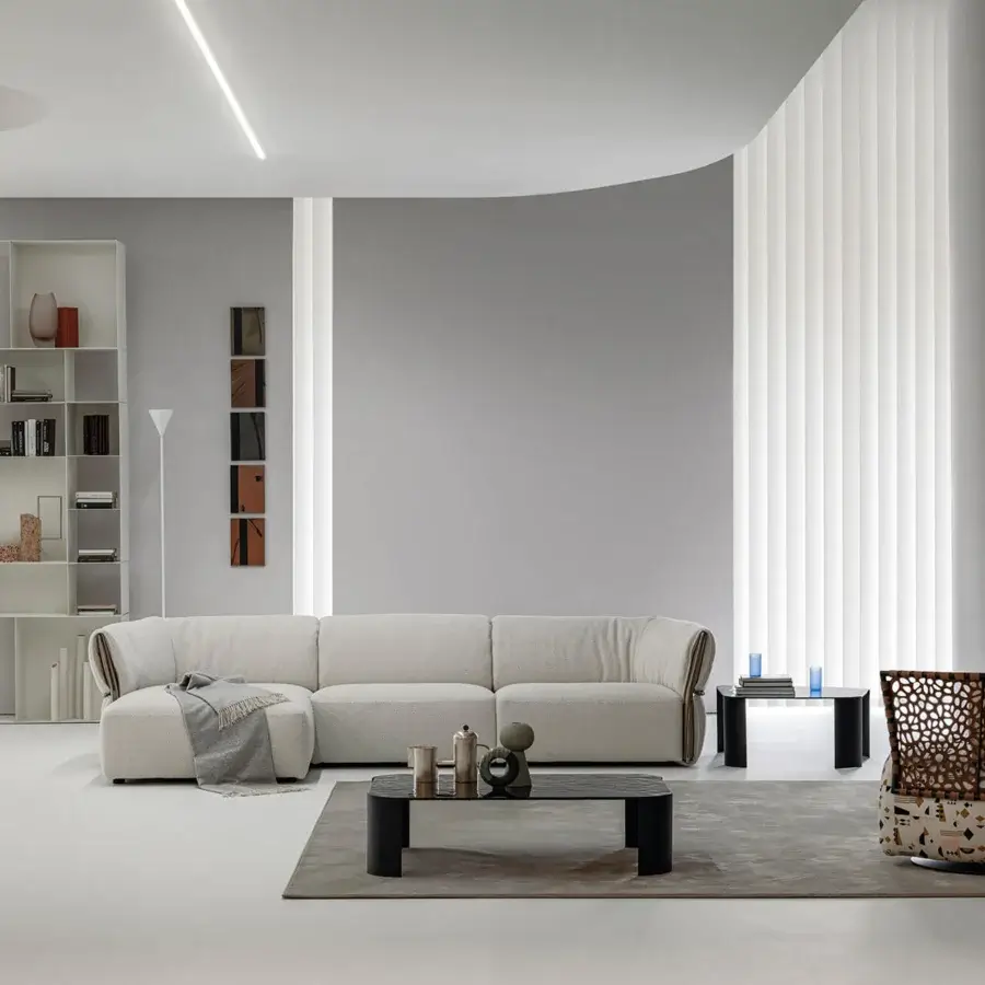 Elegant Cierre1972 Belt sectional sofa with textured off-white textile upholstery and a curved frame detail with matte finish