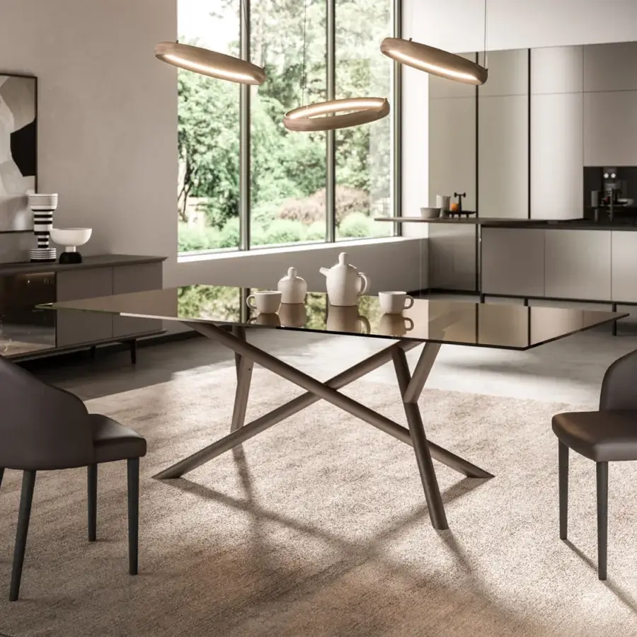 Elegant Ozzio Italia Random table with reflective glass top and intersecting muted brown wood supports
