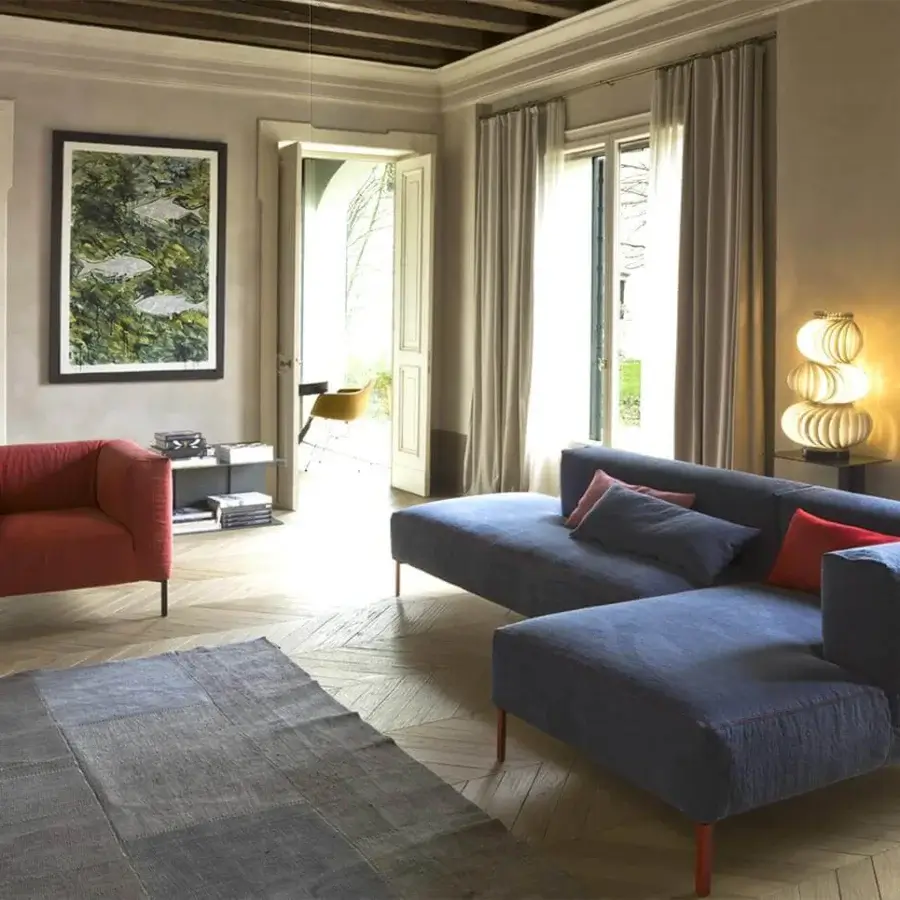 Sophisticated Verzelloni Fold lounge chair with deep red textile upholstery and sleek matte black metal feet