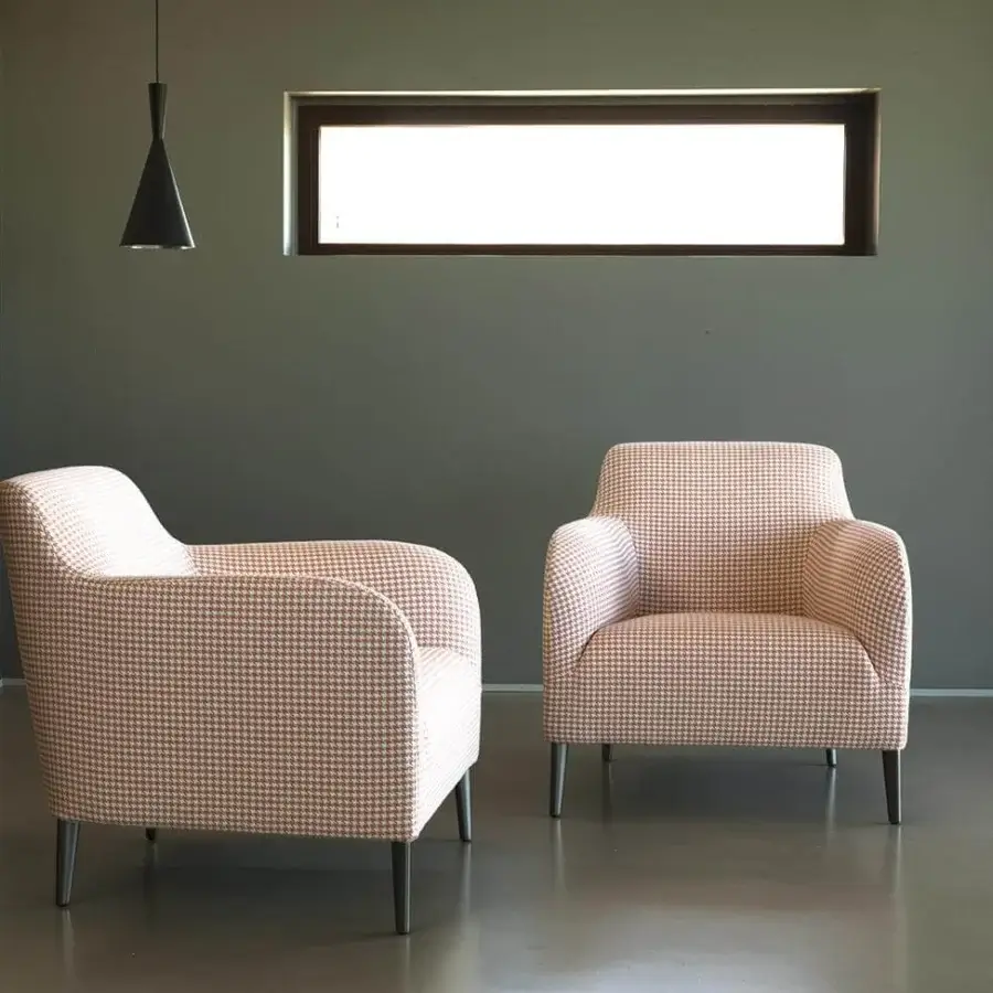 Distinguished Verzelloni Divanitas lounge chair upholstered in light pink and white houndstooth textile with burnished cast aluminum legs