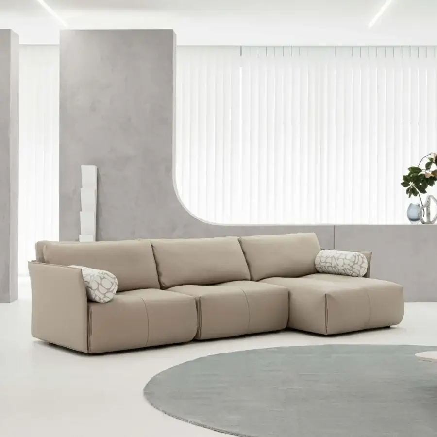 Distinguished Cierre1972 Tab Sectional tailored edge upholstered in smooth light beige textile with bolster pillows