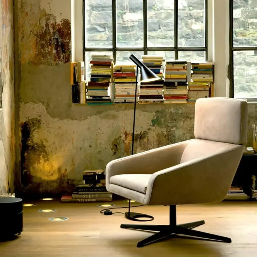 Elegant Verzelloni Sillon lounge chair upholstered in light beige textile with a matte finish and black painted cast aluminum swivel base