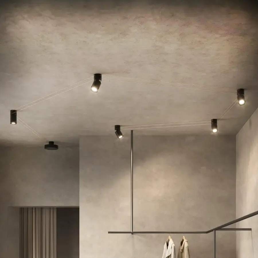 Elegant Kundalini Mitos ceiling lamp with a metallic coated structure and dark cylindrical spotlights interconnected by geometric wires