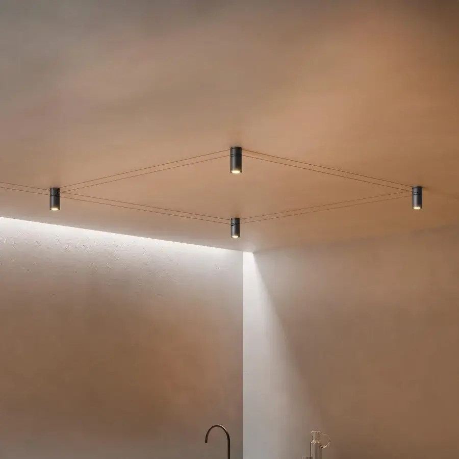 Distinguished Kundalini Mitos ceiling lamp with taut wires connecting dark metallic modules emitting warm directed light crafted in Italy