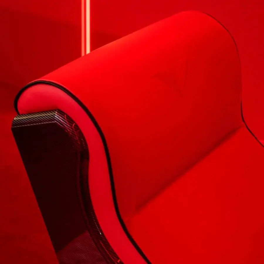 Innovative Vismara Luxor Tech home cinema seating with glossy lacquered wood and vibrant red textile upholstery showcasing diamond stitching