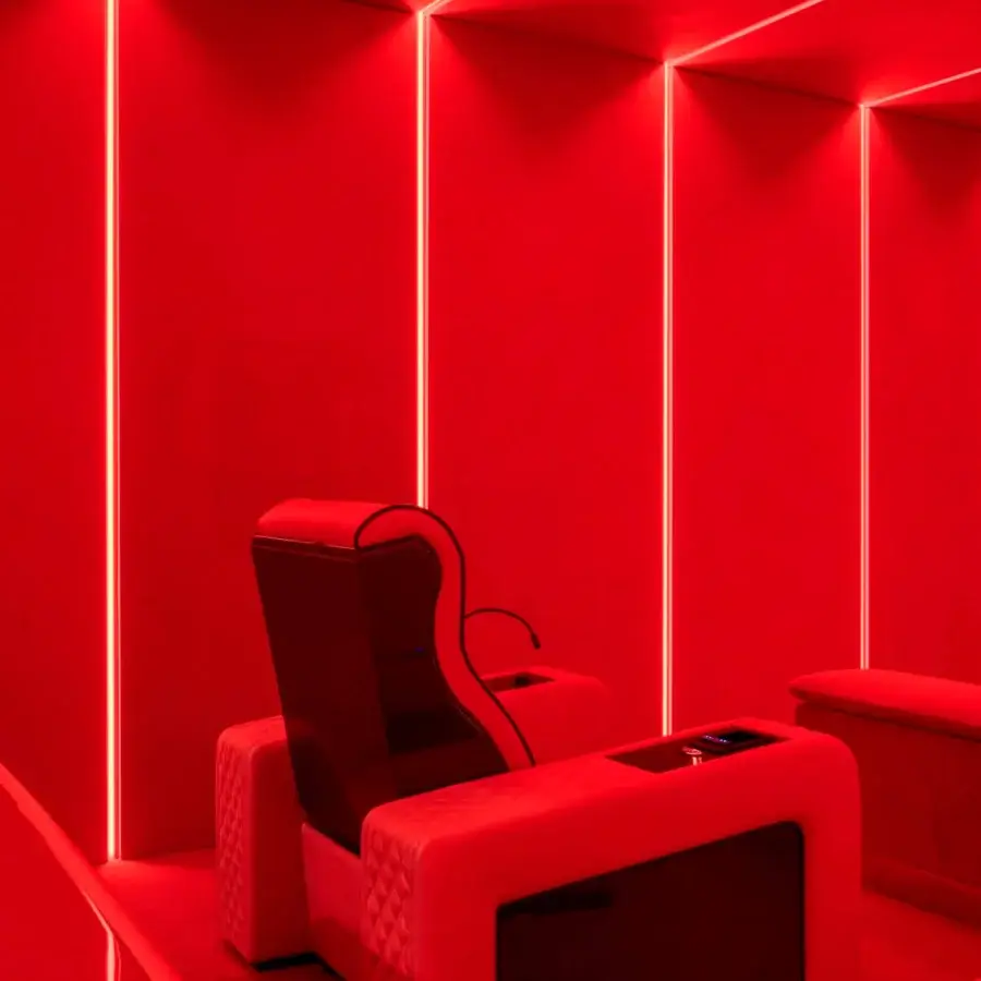 Superior Vismara Luxor Tech home cinema seating upholstered in vibrant red synthetic material with glossy lacquered wood accents