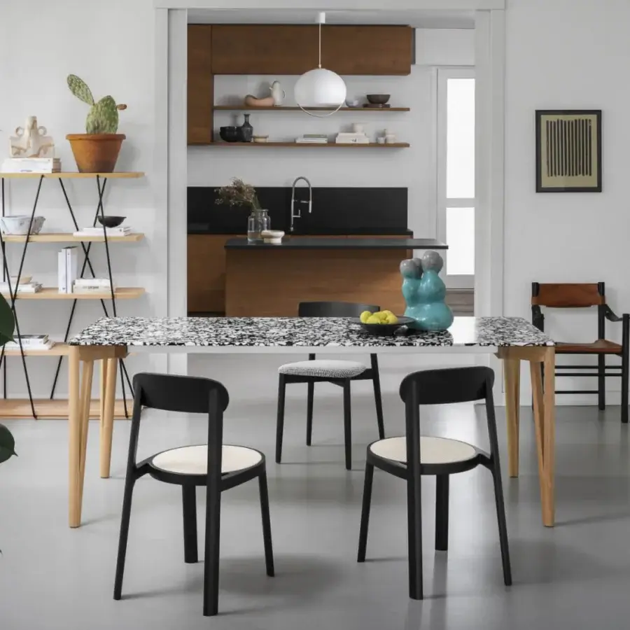 Distinguished Miniforms Decapo table crafted in Italy with speckled black and white Fenix top and light-toned wooden tapered legs