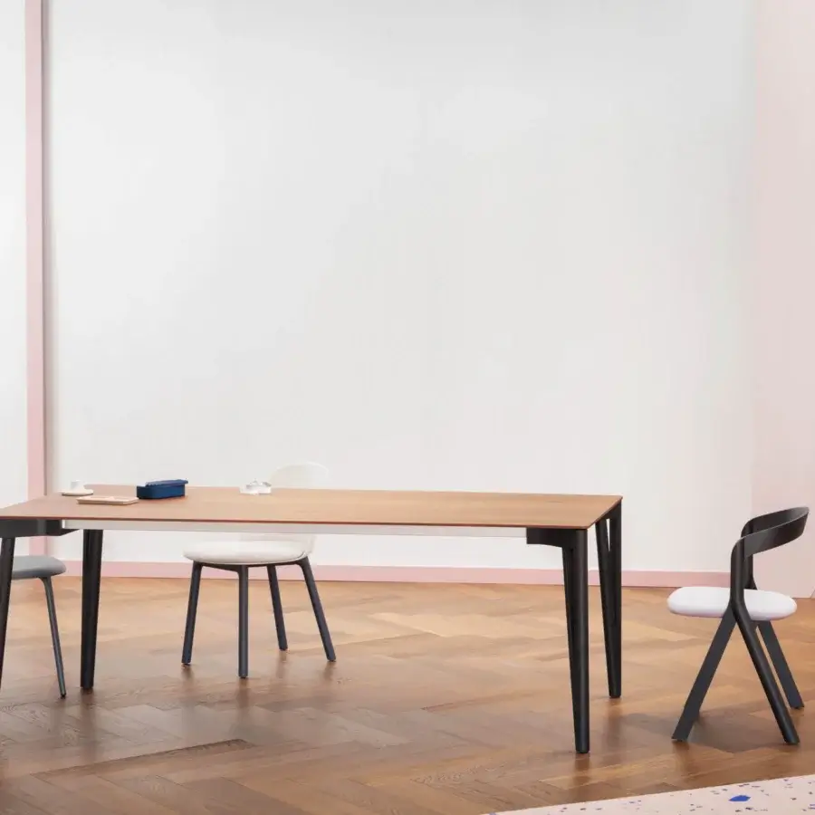 Elegant Miniforms Decapo table with light brown wooden top and slender dark V-shaped legs crafted in Italy