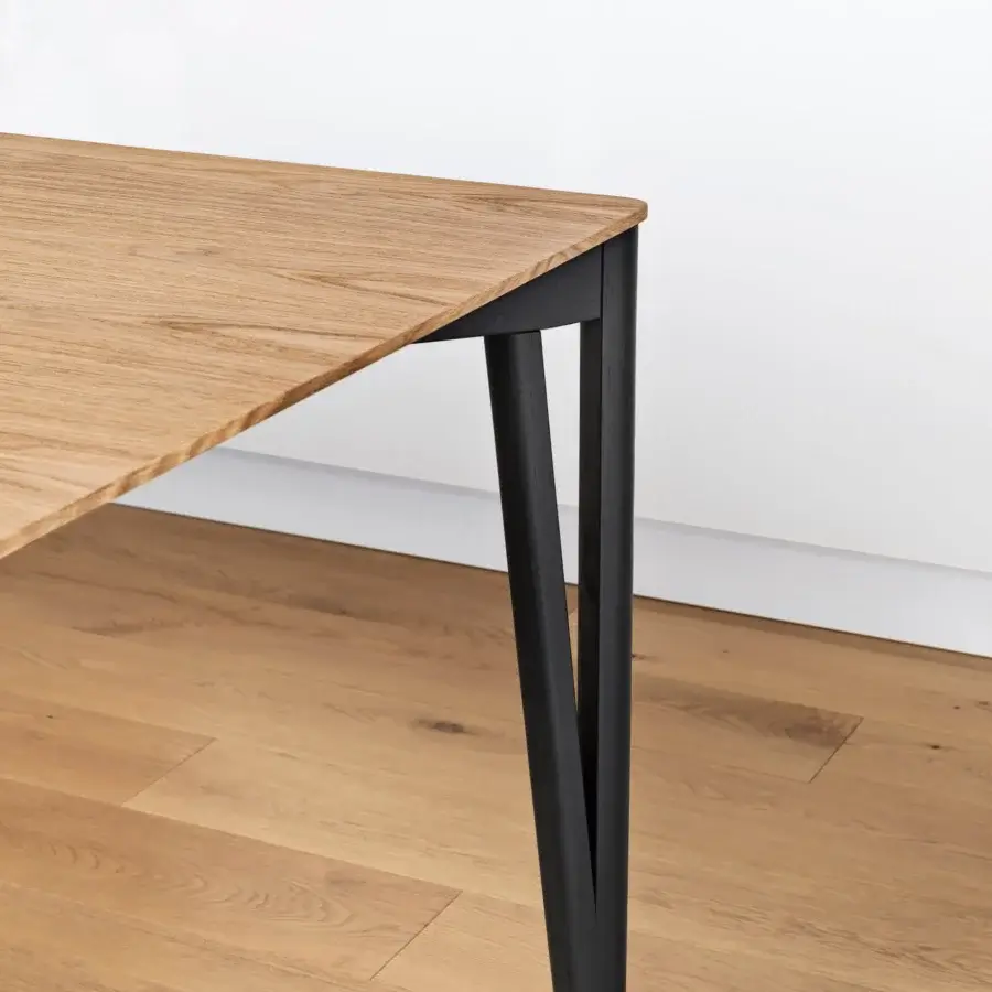 Superior Miniforms Decapo table crafted in Italy with light brown wood grain and matte black V-shaped legs